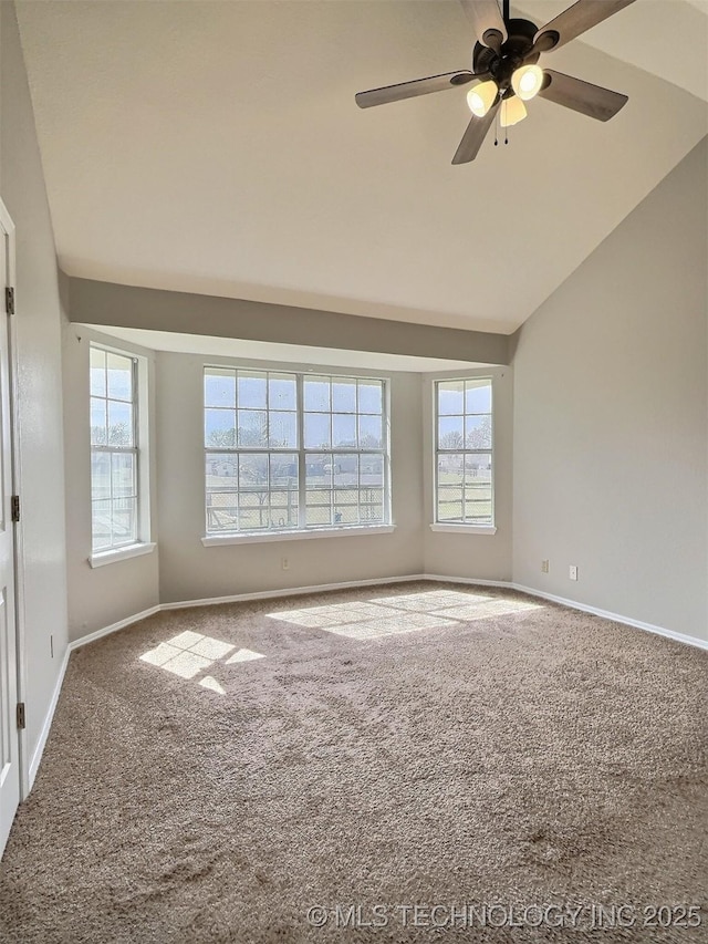 unfurnished room with ceiling fan, baseboards, lofted ceiling, and carpet floors