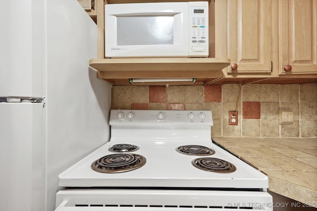 kitchen with decorative backsplash, white appliances, light brown cabinetry, and light countertops