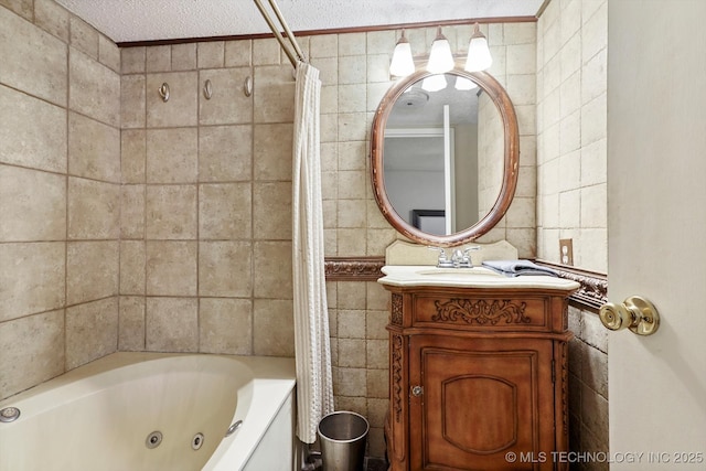 bathroom with a textured ceiling, tile walls, and vanity