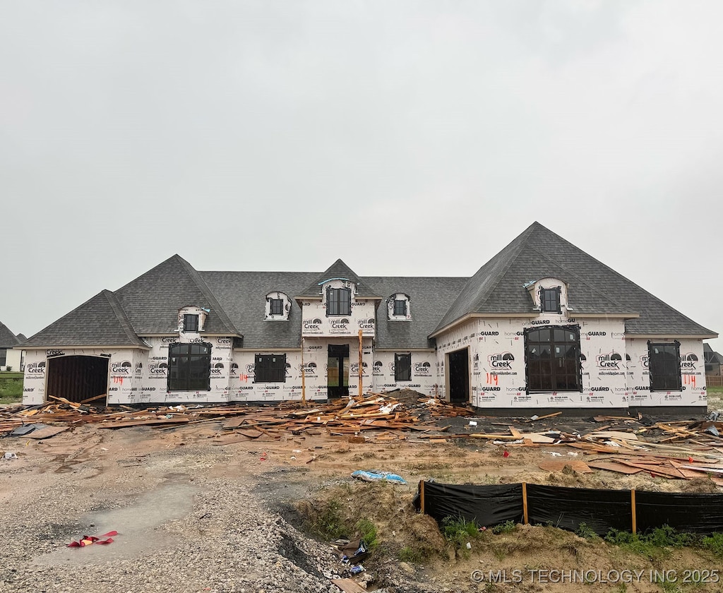 view of front of property featuring roof with shingles