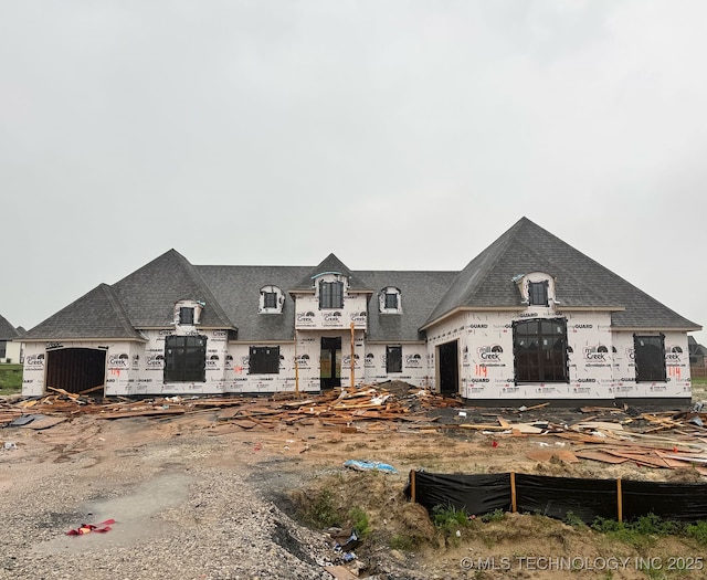 view of front of property featuring roof with shingles