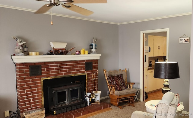 living area with ceiling fan, a fireplace, and ornamental molding