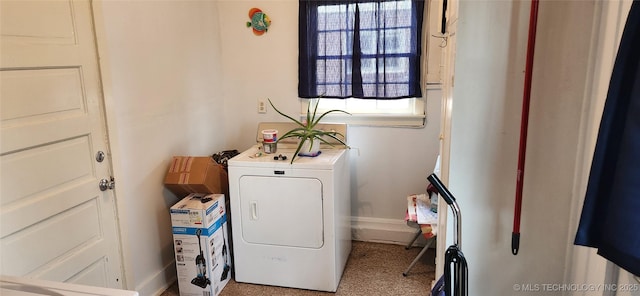 washroom with laundry area, washer / clothes dryer, and baseboards