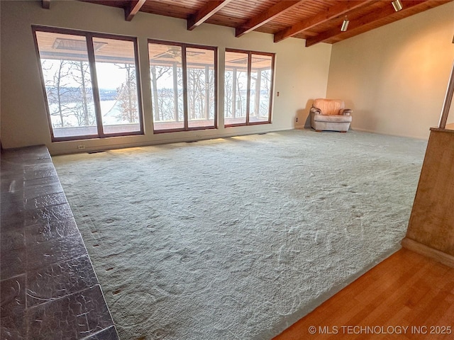 interior space featuring lofted ceiling with beams and wooden ceiling