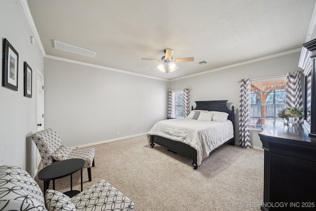 bedroom featuring visible vents, baseboards, carpet flooring, and crown molding