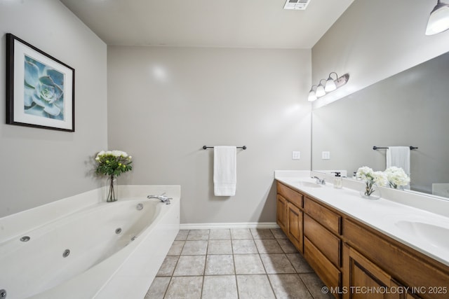 full bathroom with baseboards, double vanity, a whirlpool tub, a sink, and tile patterned floors