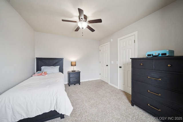 carpeted bedroom with baseboards and ceiling fan