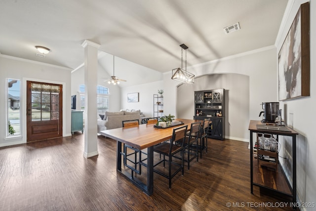 dining room featuring visible vents, dark wood-type flooring, crown molding, baseboards, and ornate columns