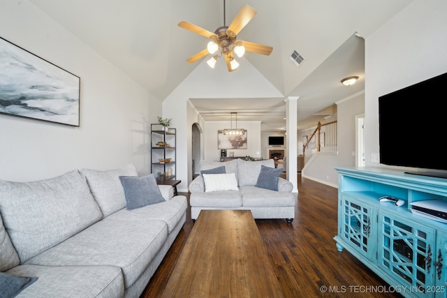 living room featuring visible vents, a ceiling fan, wood finished floors, arched walkways, and baseboards