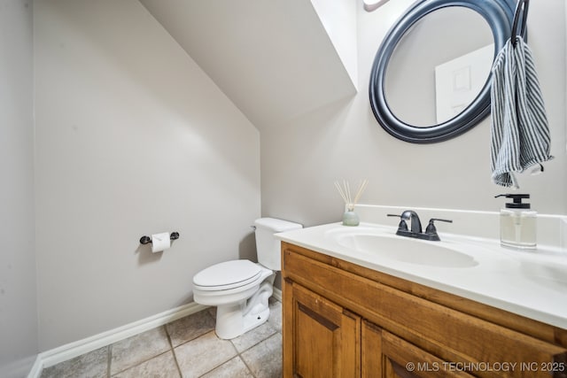 bathroom featuring tile patterned floors, baseboards, toilet, and vanity