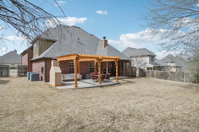 rear view of house with brick siding, a shingled roof, a chimney, a patio area, and a pergola