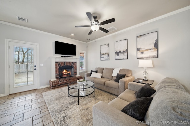 living room with visible vents, a healthy amount of sunlight, and crown molding