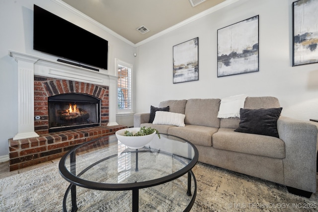 living area featuring visible vents, a fireplace, and ornamental molding