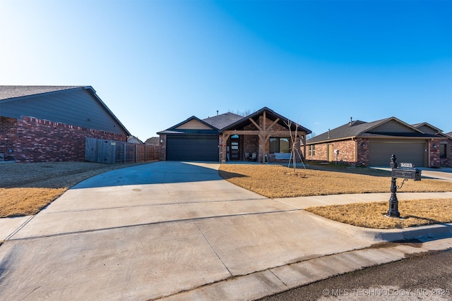 ranch-style home with a garage, brick siding, concrete driveway, and fence