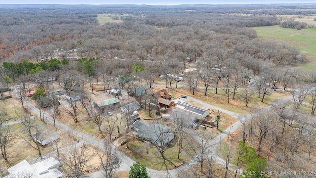 bird's eye view with a wooded view