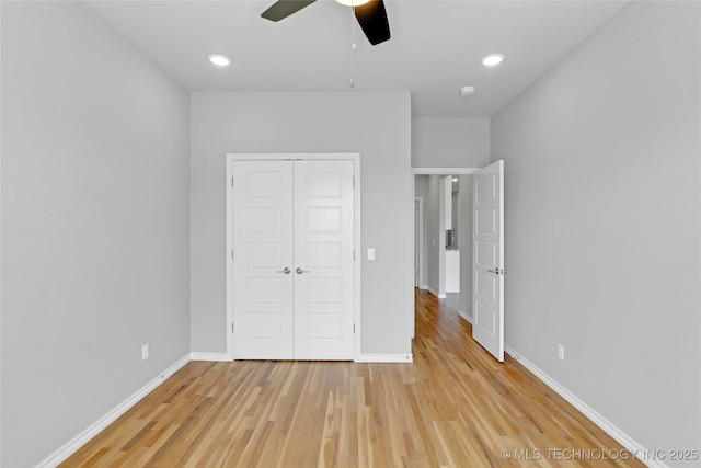 unfurnished bedroom featuring baseboards, recessed lighting, light wood-style floors, a closet, and a ceiling fan