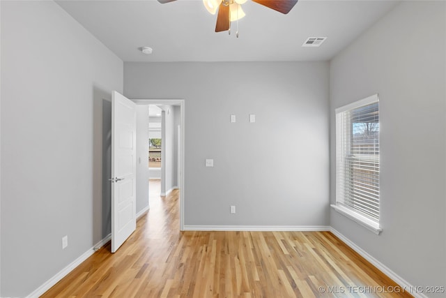 unfurnished room with visible vents, baseboards, and light wood-style floors