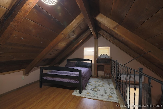 bedroom with wooden ceiling, lofted ceiling with beams, and wood finished floors