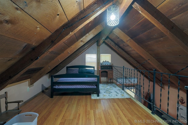 bedroom featuring wooden ceiling, vaulted ceiling with beams, and wood finished floors