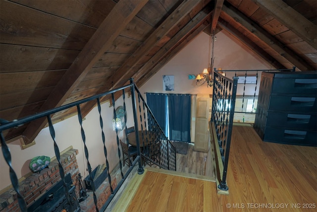 interior space featuring an inviting chandelier, wood ceiling, vaulted ceiling with beams, and wood finished floors