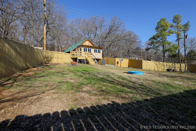 view of yard with stairway and a fenced backyard