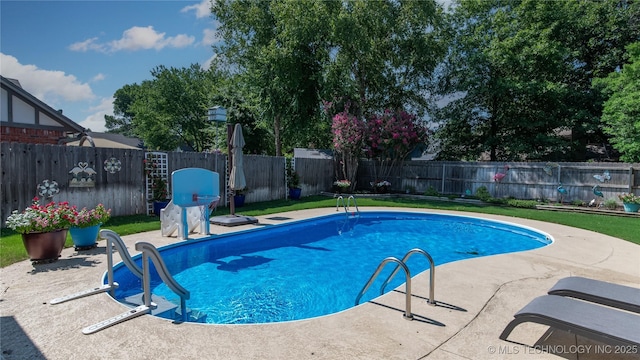 view of pool with a fenced in pool, a patio, a lawn, and a fenced backyard