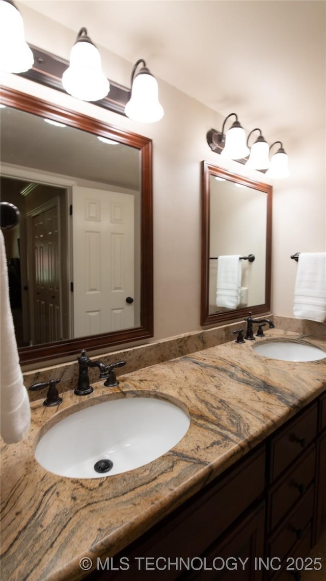 bathroom with a sink and double vanity