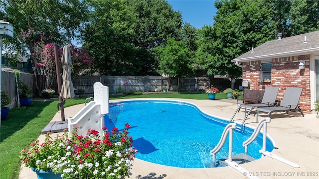 view of pool with a fenced in pool, a lawn, a fenced backyard, and a patio area