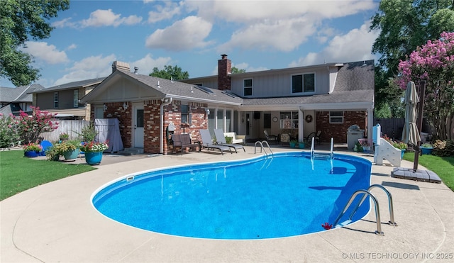 view of swimming pool featuring a patio, fence, and a fenced in pool