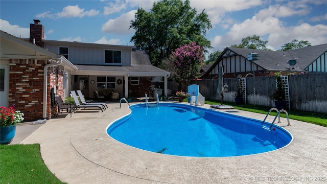 view of swimming pool featuring a fenced in pool, fence, and a patio area