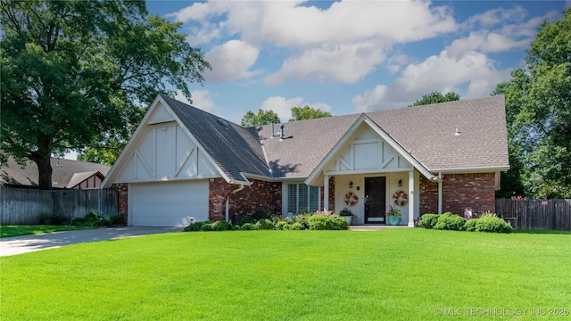 view of front facade with brick siding, fence, concrete driveway, roof with shingles, and a front yard