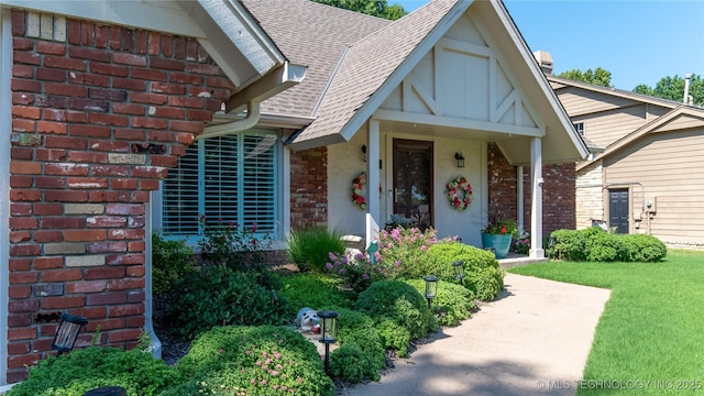 view of front of house featuring brick siding and a shingled roof