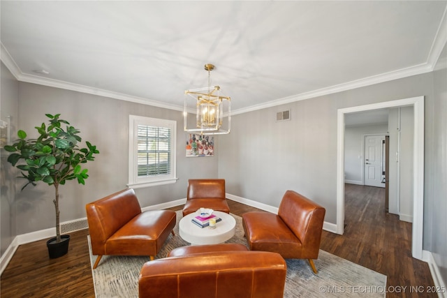 living area with visible vents, ornamental molding, baseboards, and wood finished floors