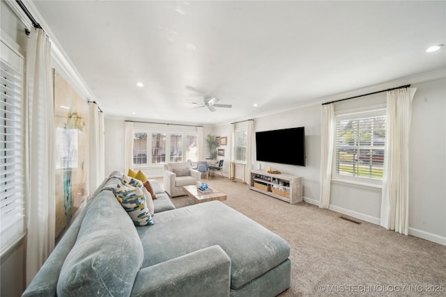 carpeted living room featuring visible vents, crown molding, baseboards, ceiling fan, and recessed lighting