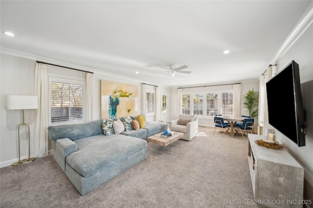 living area featuring a healthy amount of sunlight, carpet, and ornamental molding