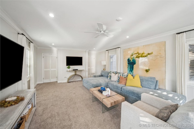 carpeted living area featuring recessed lighting, baseboards, ornamental molding, and a ceiling fan