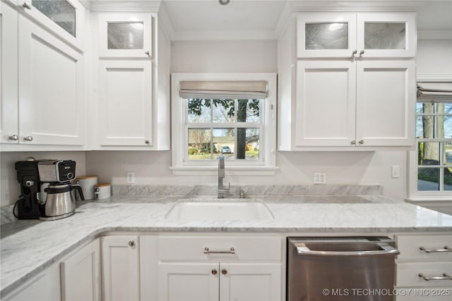 kitchen with ornamental molding, dishwasher, white cabinetry, and a sink