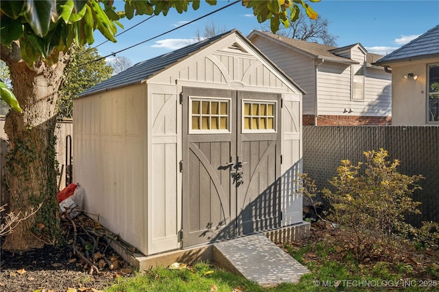 view of shed featuring fence