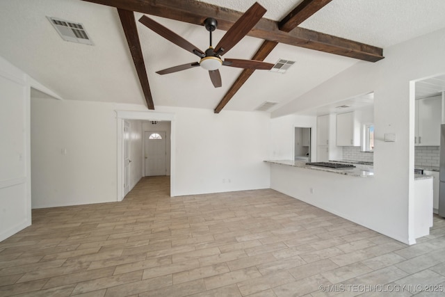 unfurnished living room featuring visible vents, lofted ceiling with beams, and a ceiling fan