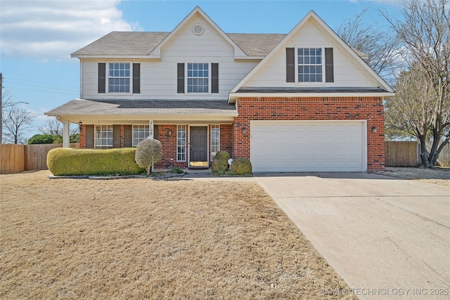 traditional-style home featuring brick siding, an attached garage, driveway, and fence