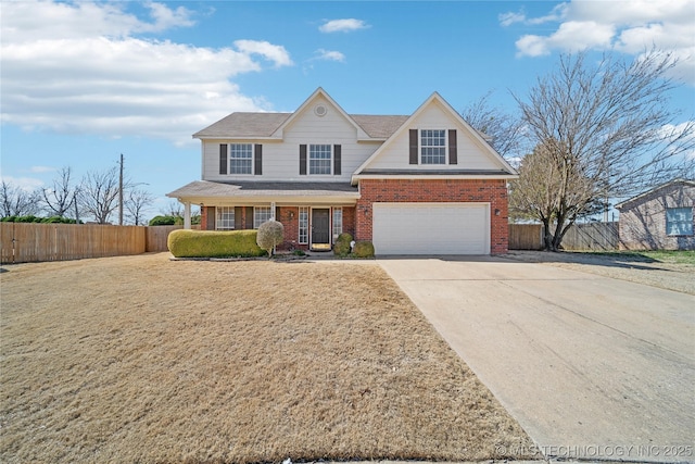 traditional home featuring an attached garage, fence, brick siding, and driveway