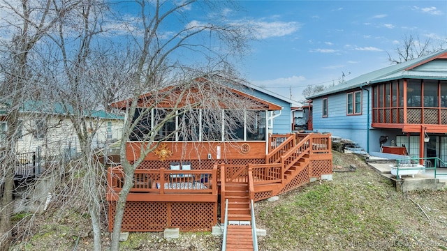 deck featuring stairs and a sunroom