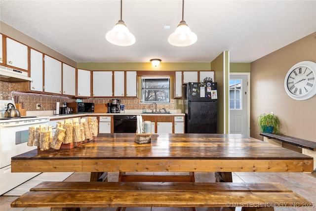 kitchen featuring backsplash, under cabinet range hood, white cabinets, black appliances, and a sink