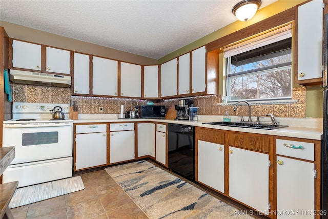 kitchen with black appliances, light countertops, under cabinet range hood, and a sink