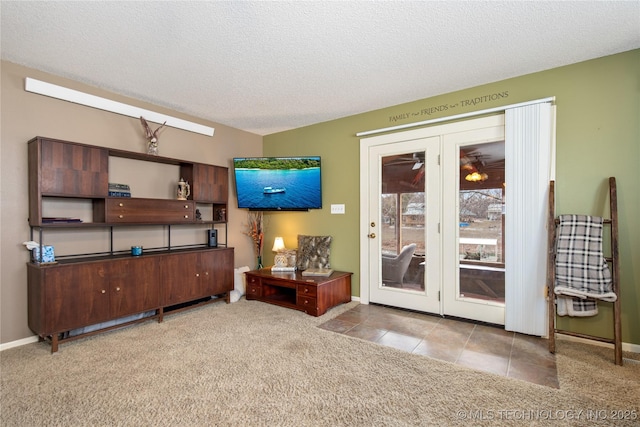 carpeted living room with tile patterned floors, baseboards, and a textured ceiling