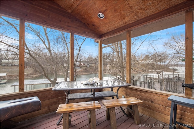 exterior space with outdoor dining space and a water view