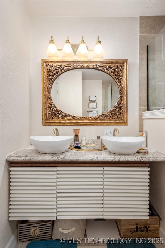 full bathroom featuring a sink and double vanity