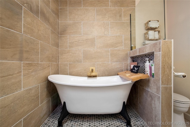 full bath featuring a soaking tub and toilet