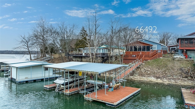 dock area featuring boat lift and a water view