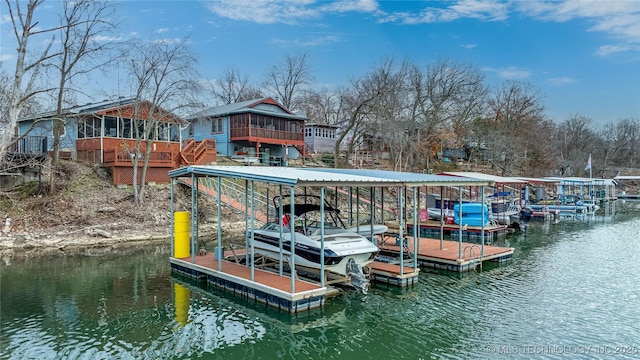 dock area with boat lift and a water view